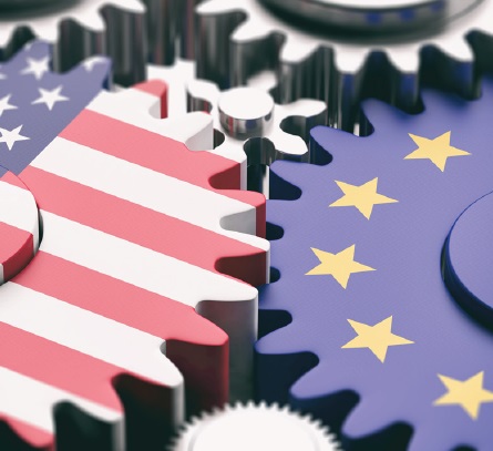 Ozubená kolečka s vlajkami USA a EU